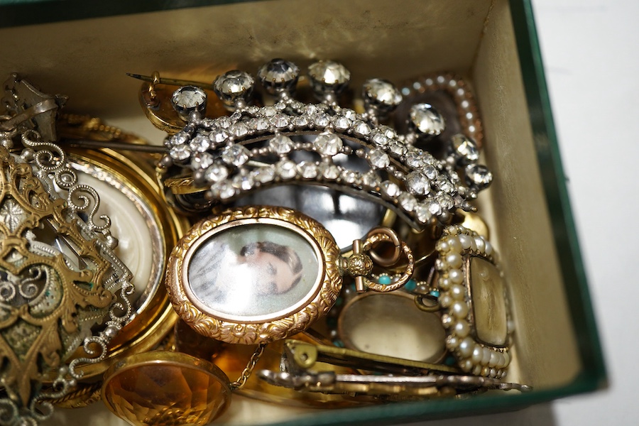 Six assorted 19th century mourning brooches including William IV yellow metal with plaited hair date 1834 and George III with split pearl and hair, largest with carved wax? panel depicting deer, 56mm, a Murrle Bennet & C